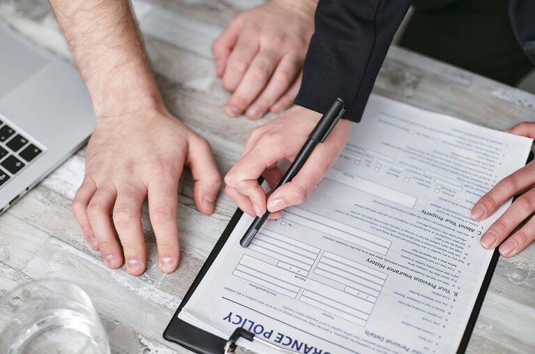 People looking at Insurance Policy documents